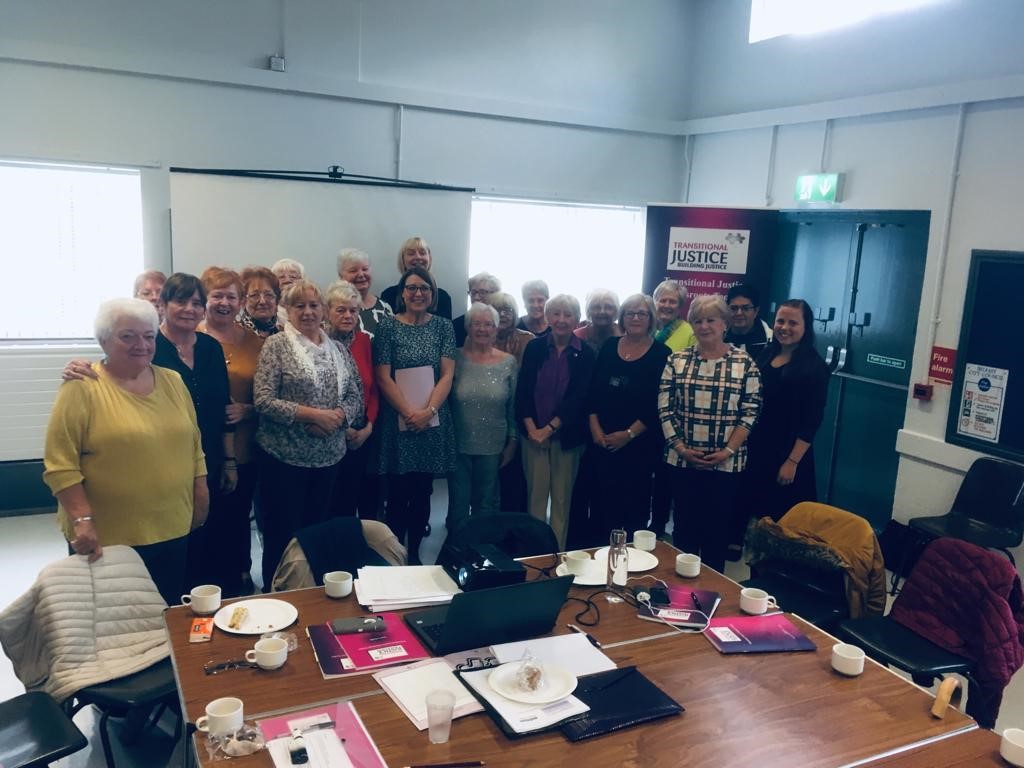 Victims Commissioner Judith Thompson presenting certificates to women from Lenadoon who completed a Transitional Justice Grassroots Toolkit programme with Bridge of Hope and Legacy Coordinator Aine Magee
